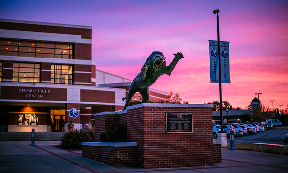 The UAFS Numa Statue in front of the UAFS Stubblefield Center at sunset